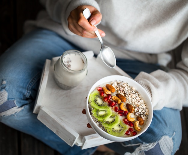 Girl eating porridge with fruit