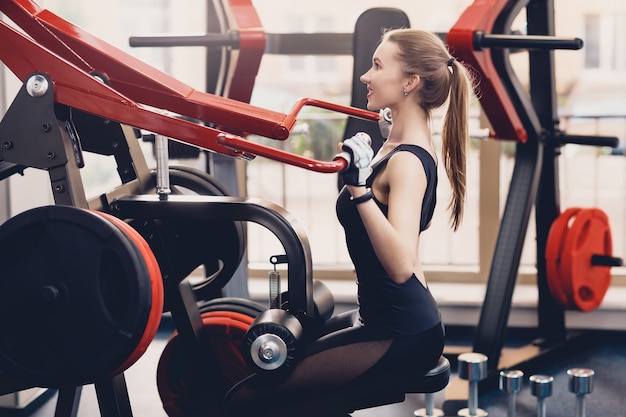 Girl engaged the training apparatus for the backs