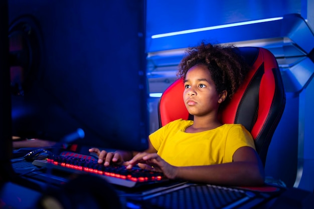 Girl enjoying her free time by playing video games on computer in game room