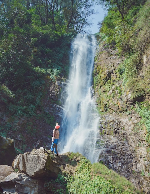 A girl enjoying in natural water fall