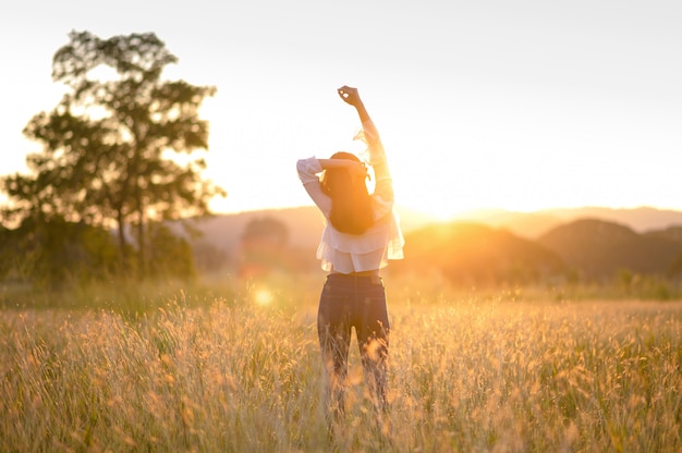 Girl enjoying nature on the field.Sun Light. Glow Sun. Free Happy Woman