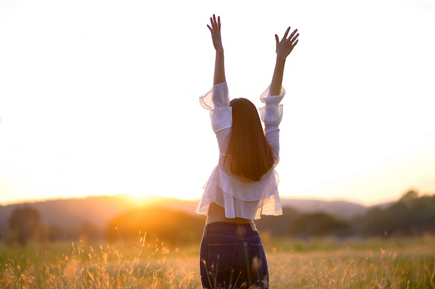 Girl enjoying nature on the field.Sun Light. Glow Sun. Free Happy Woman