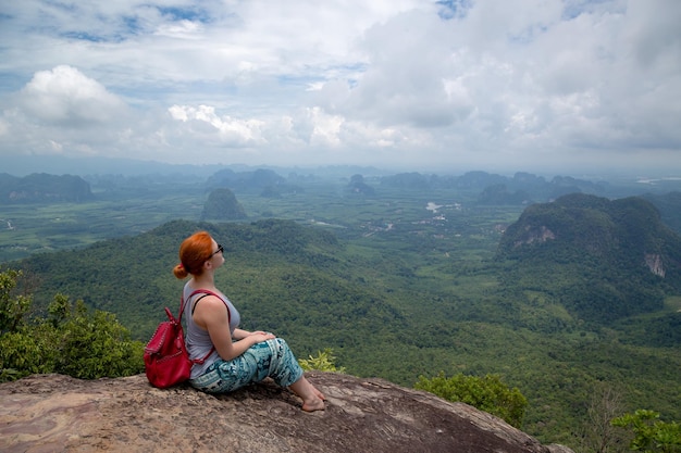 소녀는 크라비 태국(Krabi Thailand) 관점에서 계곡과 안다만 해(Andaman Sea) 섬과 산의 아름다운 전망을 즐깁니다.