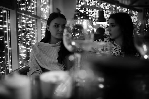 The girl in the evening rest in a cafe for a cocktail