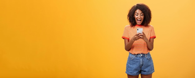 Girl expressing excitement and joy receiving awesome invitation via messages yelling from delight an