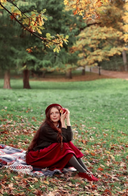 girl in a fabulous bow in the autumn park