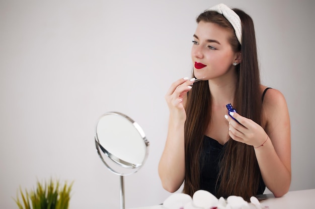 Girl facial in front of a mirror brunette has a hoop