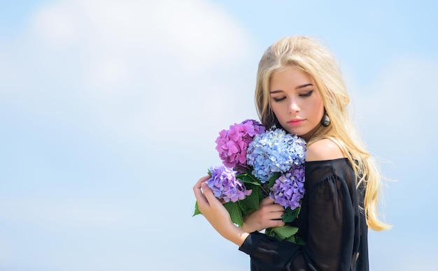 Girl fashion model carry hydrangea flowers. Spring fresh bouquet. Flowers tender spring fragrance. Bouquet for girlfriend. Fashion and beauty industry. Celebrate spring. Gardening and botany concept.