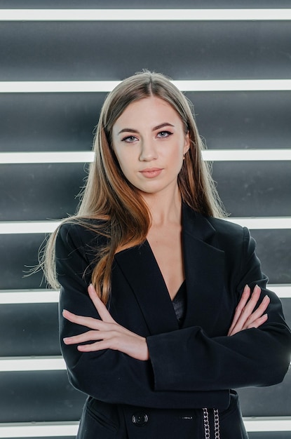 Girl fashion model posing in a black jacket