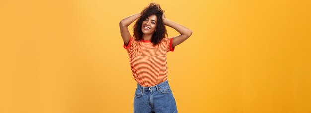 Girl feeling awesome making cool hairstyle posing near mirror feeling glad to have date tonight person