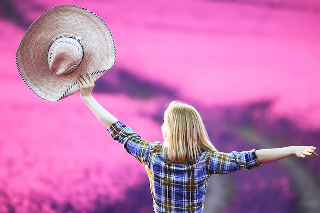 girl in a field of lilac flowers in lavender colors, violet and pink landscape, happy and harmony