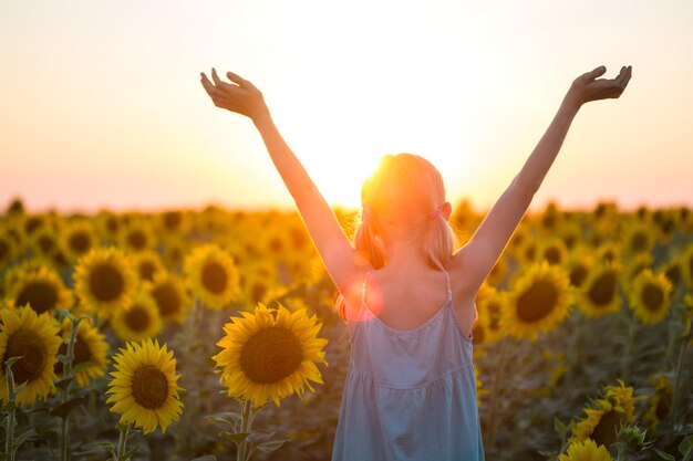 Girl at the field of sunflowers