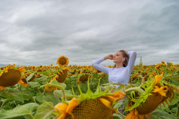 Girl in the field with sunflowers. Sunflowers.