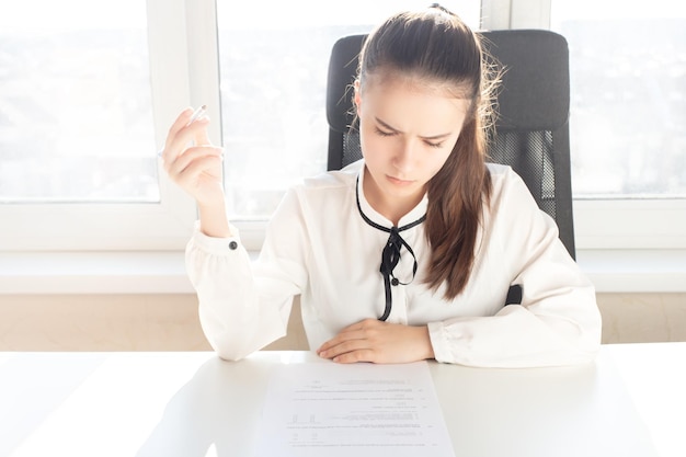 Girl fills an employment contract in the office