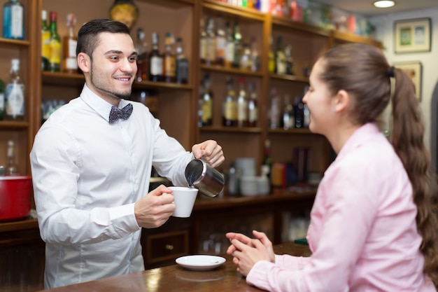 Girl flirting with barman at counter