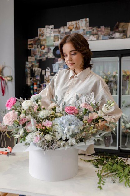 Girl florist collects a composition