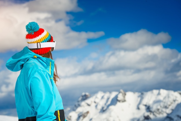 Girl freeride skier looks at the distant mountains