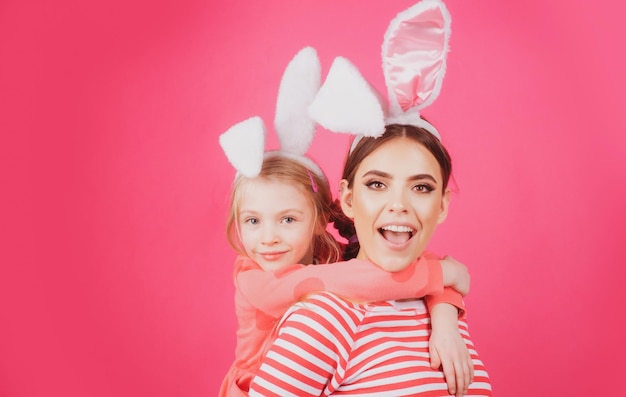 Girl friends happy easter Happy childhood concept Small sister female bunny ears isolated on pink background