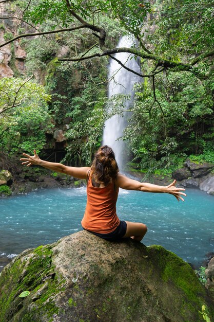 Girl in front of the waterfall