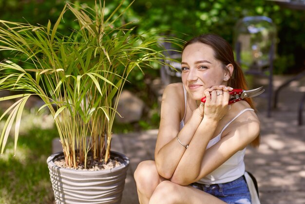 Girl gardener caring for plants with a smile