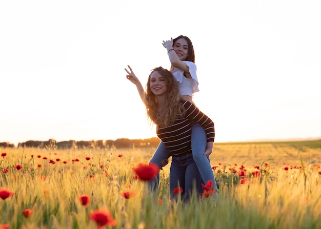 Girl gives a big hug and climbs on her friend's back on a very happy day.