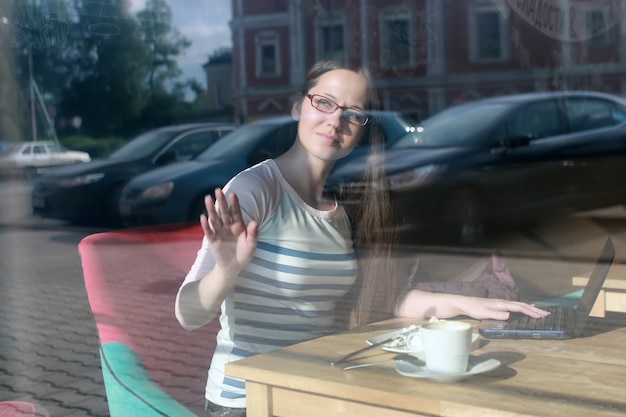 Girl behind glass in cafe