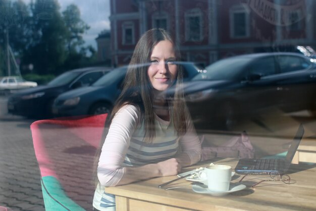 Girl behind glass in cafe