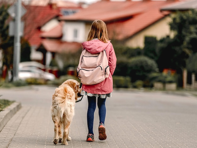 Girl and golden retriever dog