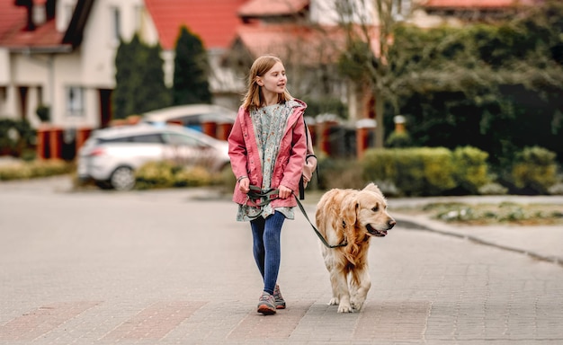 Girl and golden retriever dog