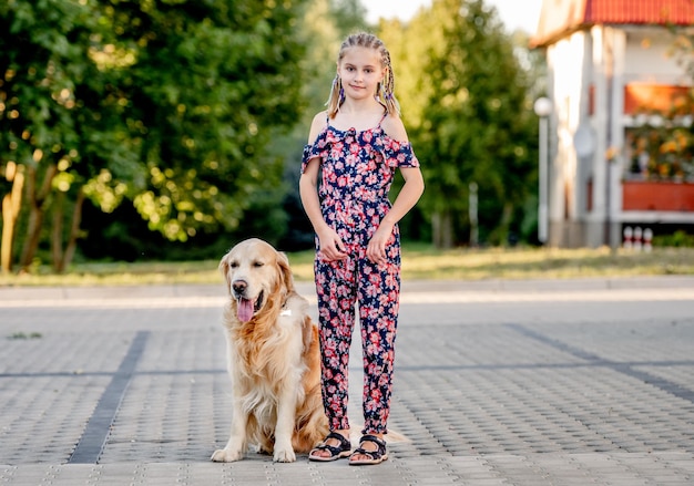 Girl and golden retriever dog