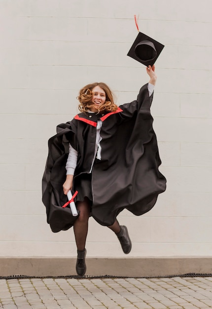 Photo girl at graduation jumping