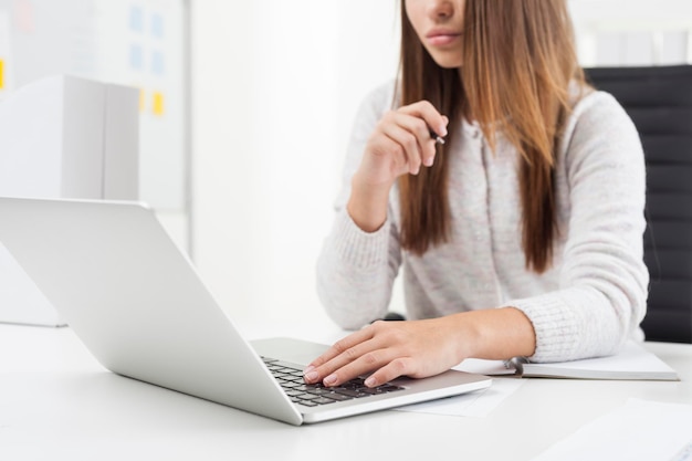 Girl in gray cardigan is typing