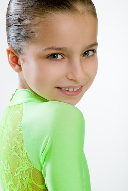 Girl in a green dress for ballroom dancing