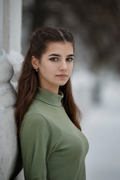 A girl in a green jacket on the street