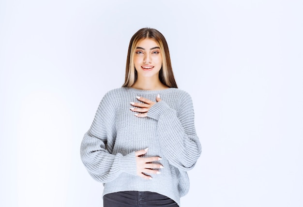 Girl in grey shirt looking happy and motivated.