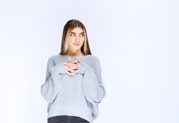 Girl in grey shirt looks confused and thinking.