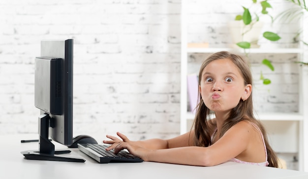 Girl grimaced front of a computer