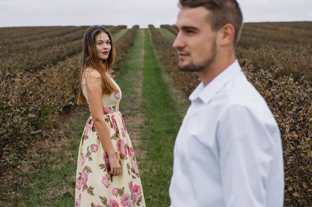 A girl and a guy are walking in the nature.