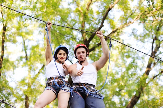 A girl and a guy in a special safety equipment in the nature