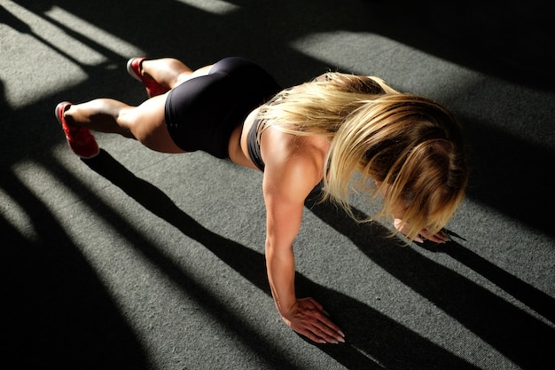 Girl in gym doing push ups