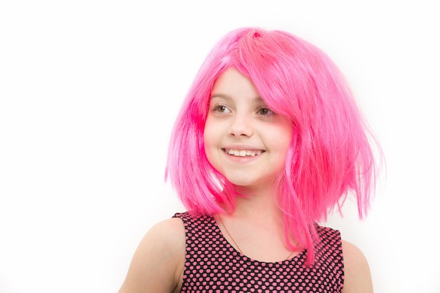 Girl happy smile in pink wig hair isolated on white. Child and childhood concept. Fashion and beauty. Birthday, anniversary, holiday celebration, copy space