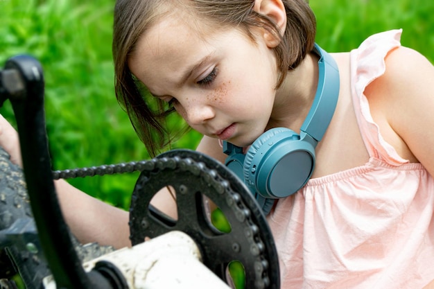 Girl has damaged bicycle wheel and making repairs