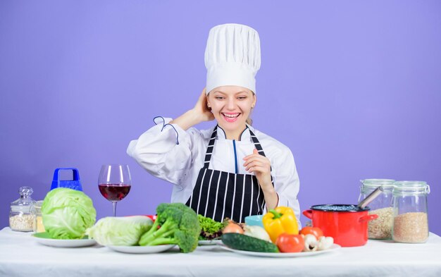 Girl in hat and apron delicious recipe concept cooking healthy food fresh vegetables ingredients for cooking meal lets start cooking woman chef cooking healthy food gourmet main dish recipes