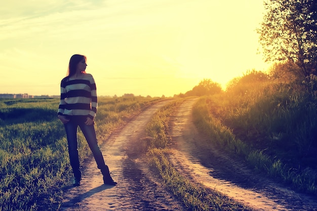 Girl in hat fashion field sunset