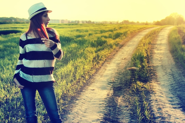 Girl in hat fashion field sunset