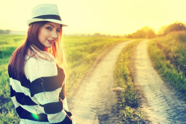 Girl in hat fashion field sunset