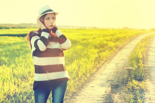 Girl in hat fashion field sunset