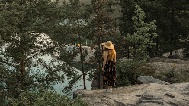 Girl in a hat travels to beautiful places of the planet, summer day