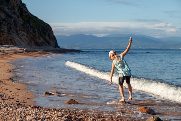 Girl having fun at the beach on a wild coast