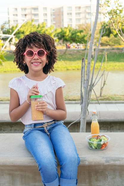 Girl having a healthy drink in the park